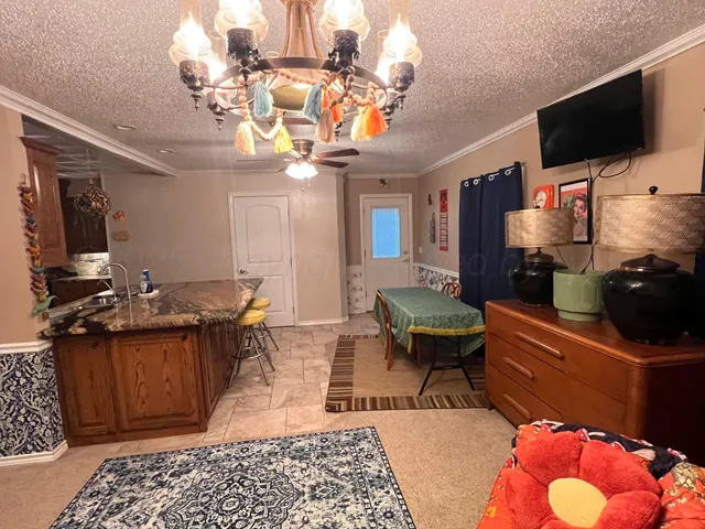 a kitchen with stainless steel appliances granite countertop a sink a stove and a wooden floors