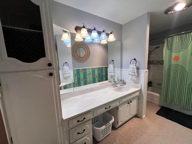 a bed sitting in a bedroom next to a chandelier