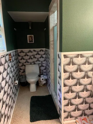 a bedroom with a bed and a mirror