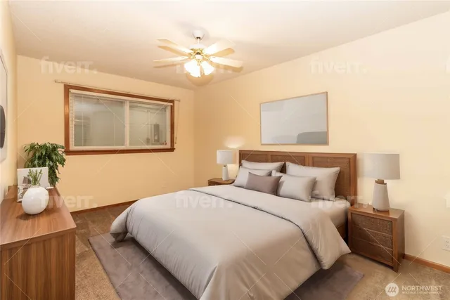 a bedroom with a large bed and a chandelier