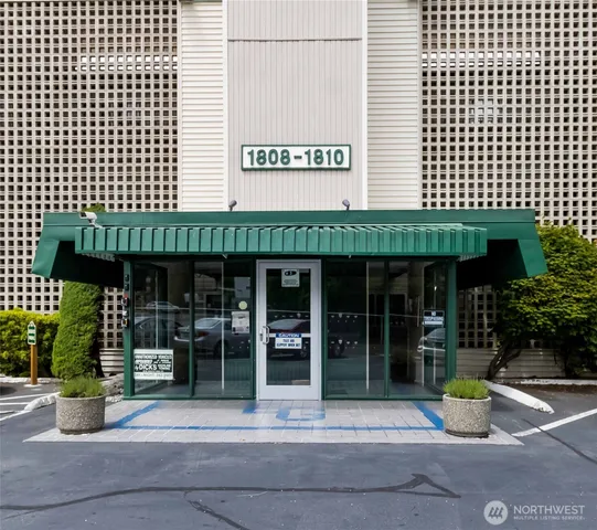 a front view of a building with a garden