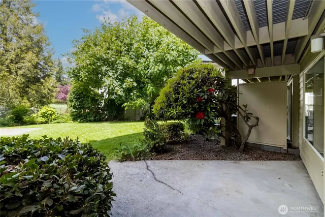 a view of a patio with table and chairs and potted plants