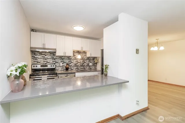 a kitchen with a sink and a potted plant