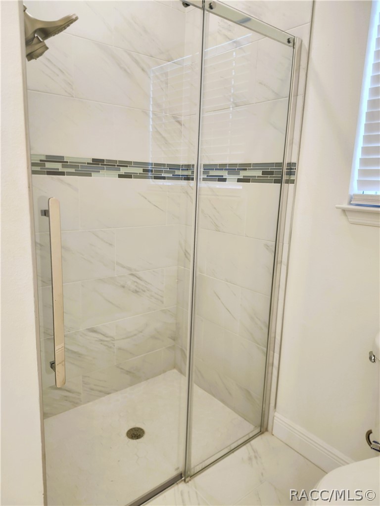 2800 Southwest 139th Street Ocala, FL 34473 - Photo 12 of 16 a bathroom with a glass shower door