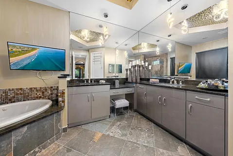 a bathroom with a tub sink and mirror