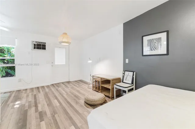 a bedroom with two beds and painting on the wall