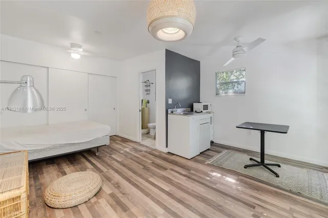a view of a kitchen with a sink and a refrigerator
