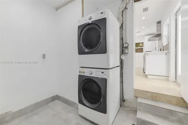 a view of a hallway with washer and dryer