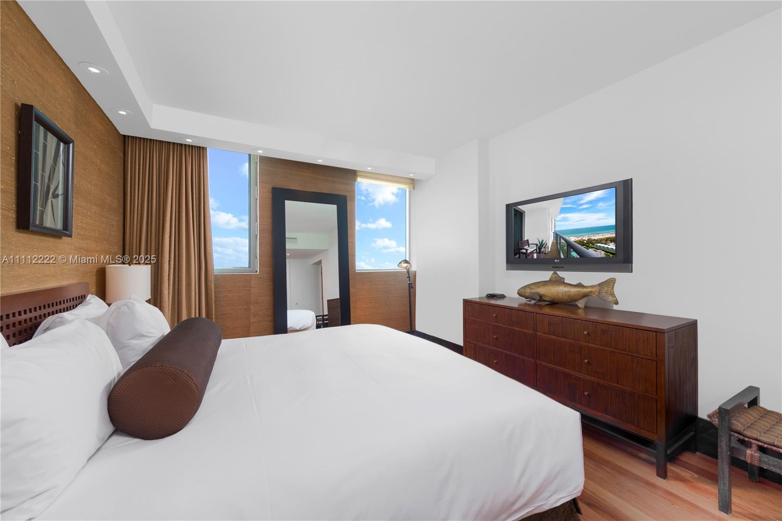 101 20th Street, Unit 2402 Miami Beach, FL 33139 - Photo 12 of 23 a bedroom with a bed and wooden floor