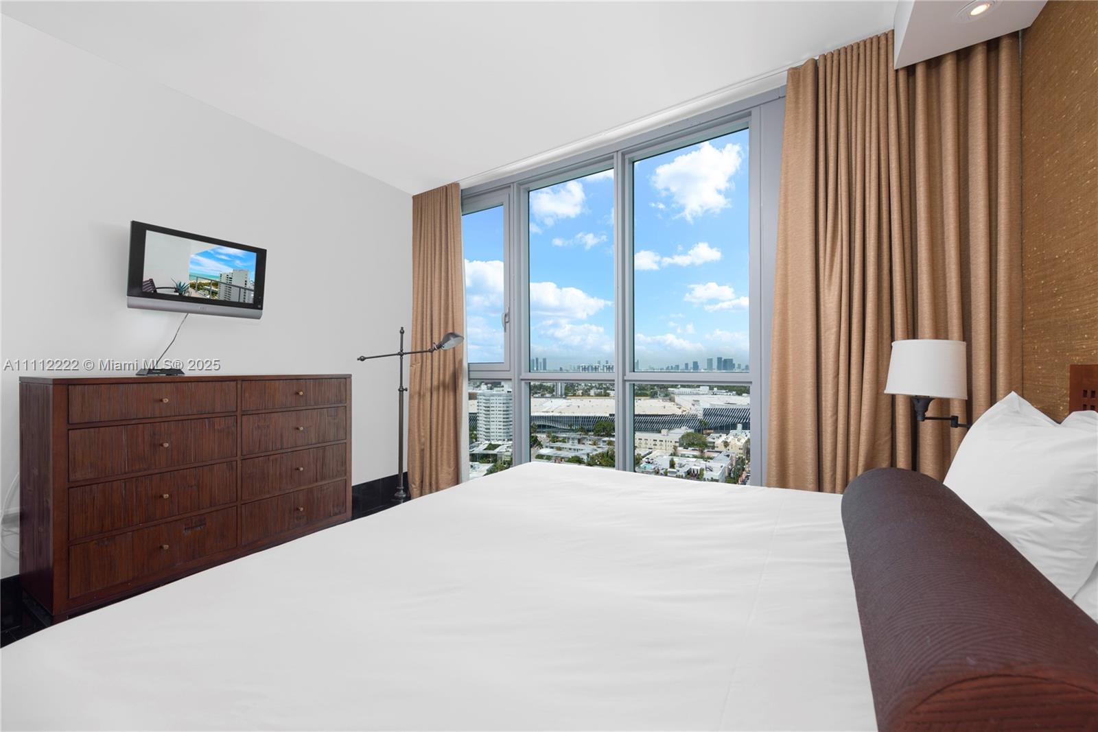 101 20th Street, Unit 2402 Miami Beach, FL 33139 - Photo 18 of 23 a bedroom with a large bed and a large window