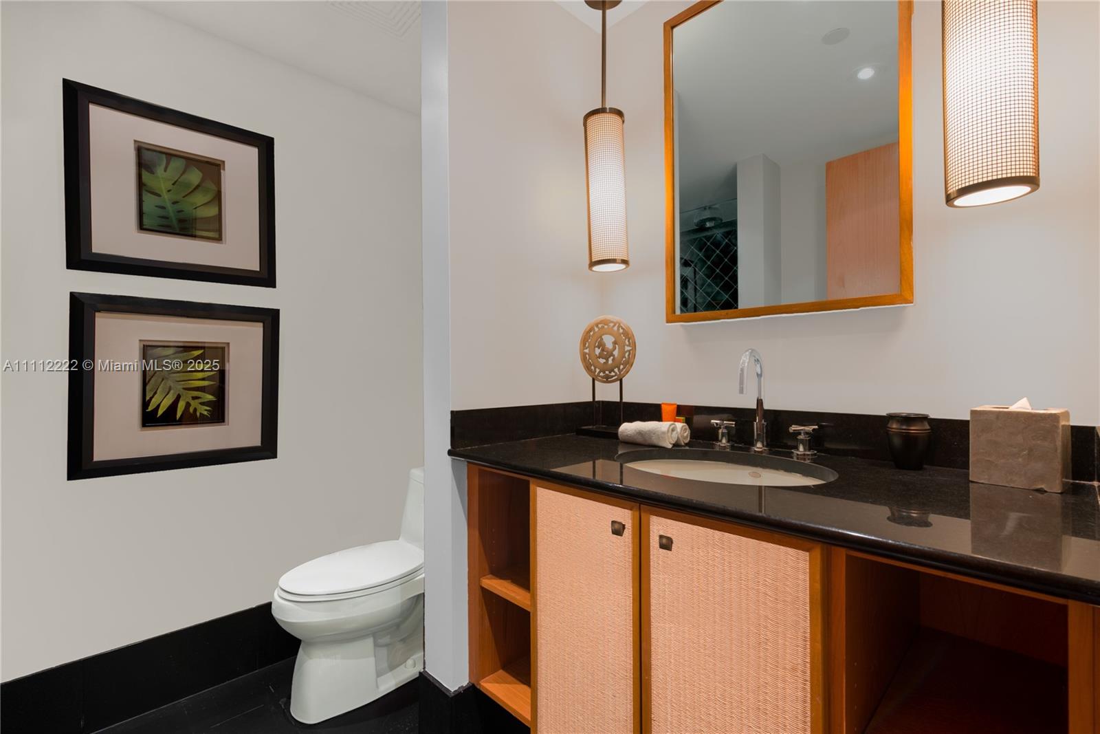 101 20th Street, Unit 2402 Miami Beach, FL 33139 - Photo 19 of 23 a bathroom with a granite countertop sink and a mirror