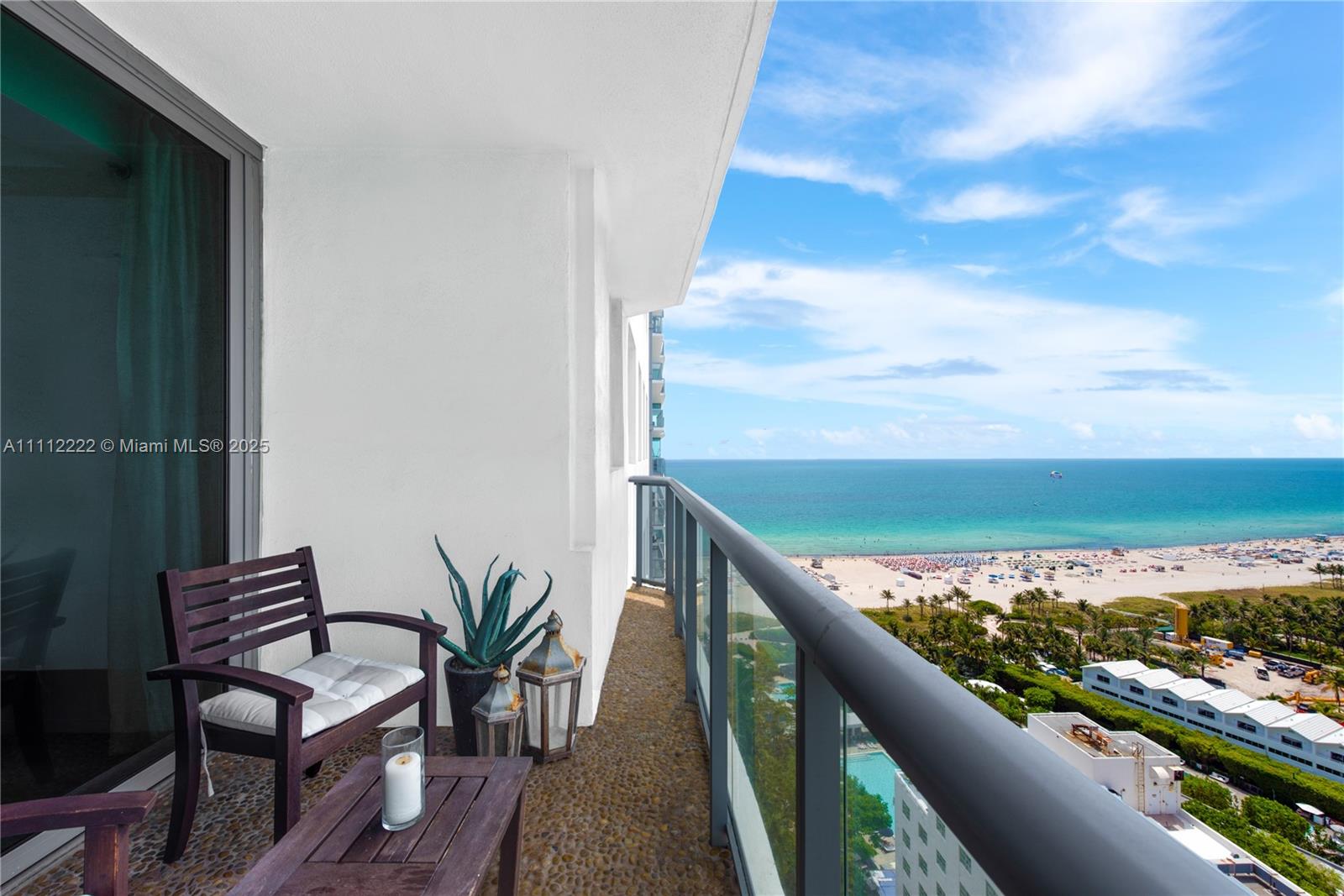 101 20th Street, Unit 2402 Miami Beach, FL 33139 - Photo 2 of 23 a view of a balcony with wooden floor and outdoor seating