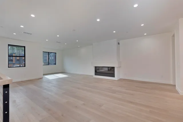 a view of an empty room with a fireplace
