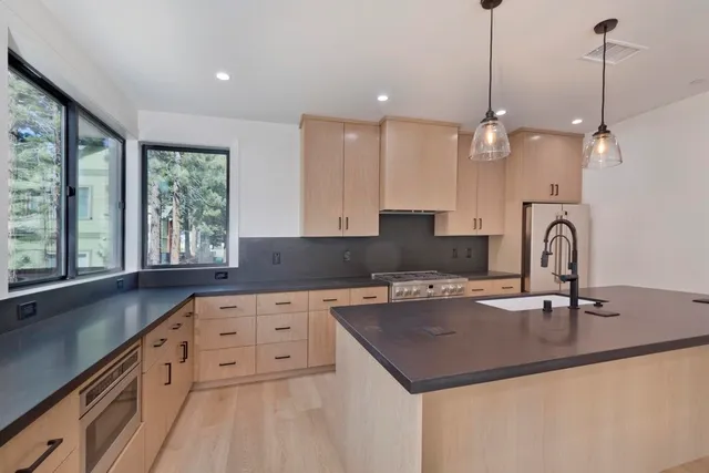 a kitchen with a sink window and cabinets