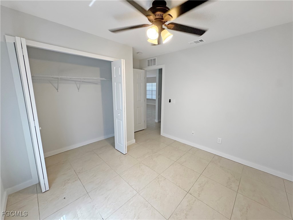 210 Manatee Street Fort Myers, FL 33913 - Photo 13 of 27 an empty room with a fan and a fan