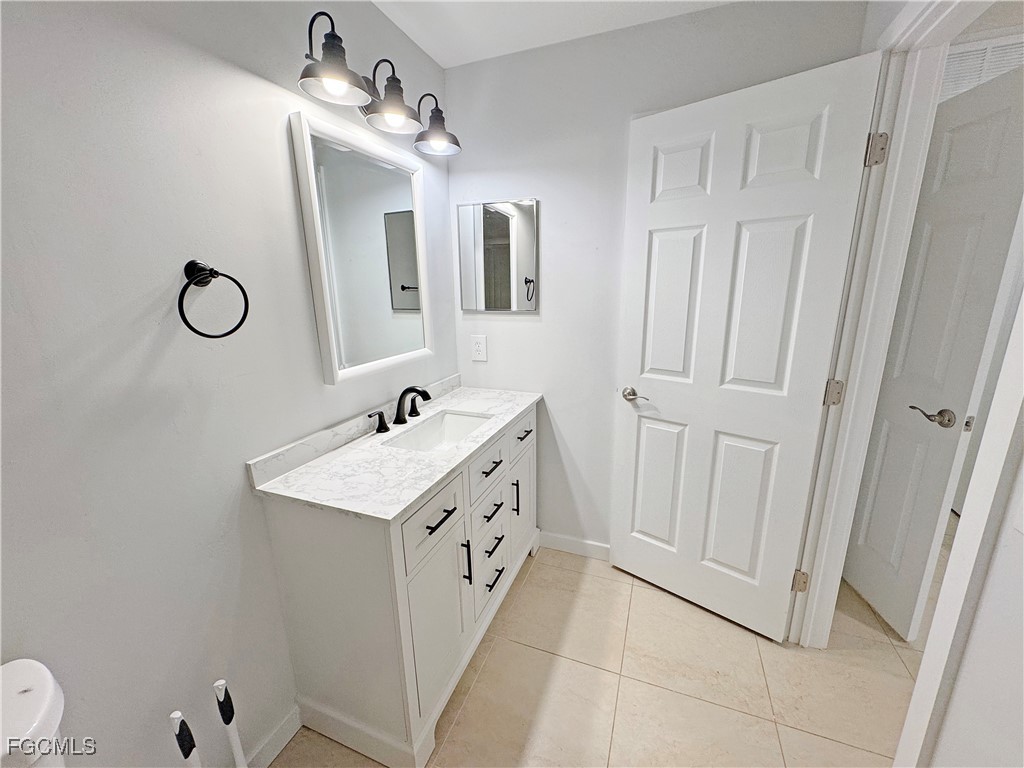 210 Manatee Street Fort Myers, FL 33913 - Photo 15 of 27 a bathroom with a sink a mirror and a shower