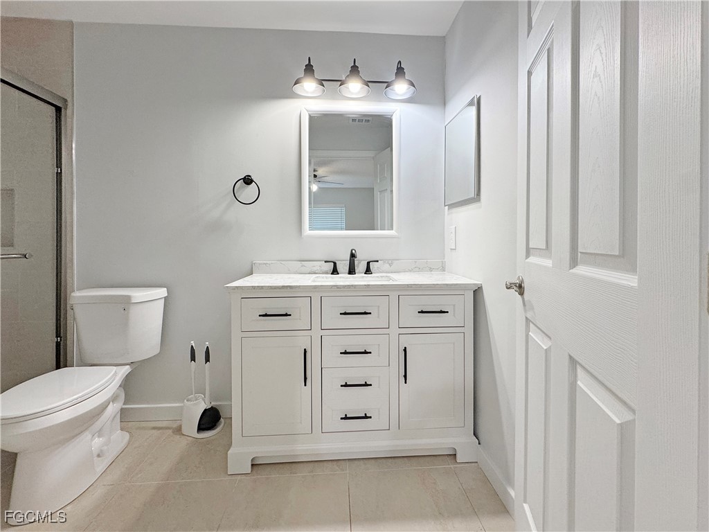 210 Manatee Street Fort Myers, FL 33913 - Photo 16 of 27 a bathroom with a sink vanity mirror and toilet