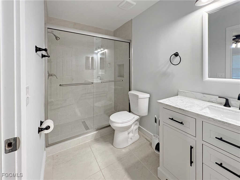 210 Manatee Street Fort Myers, FL 33913 - Photo 17 of 27 a bathroom with a toilet sink and shower