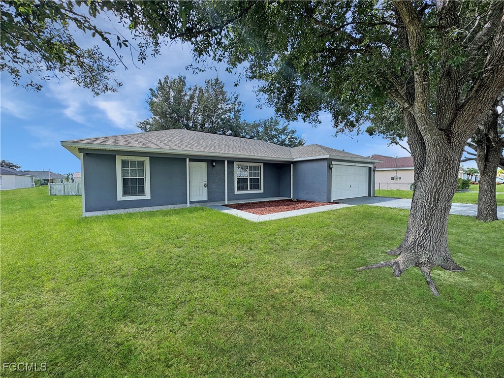 210 Manatee Street Fort Myers, FL 33913 - Photo 2 of 27 a front view of a house with a garden