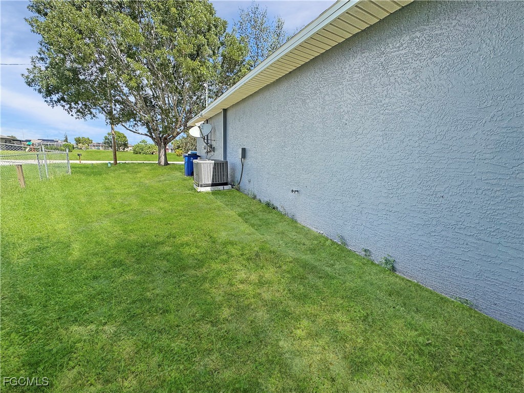 210 Manatee Street Fort Myers, FL 33913 - Photo 27 of 27 a view of a backyard with a garden and trees