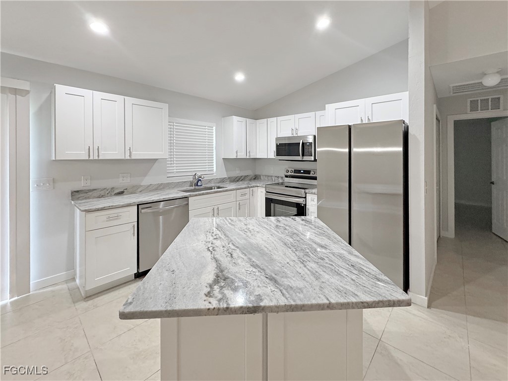 210 Manatee Street Fort Myers, FL 33913 - Photo 7 of 27 a kitchen with stainless steel appliances granite countertop a refrigerator sink and stove