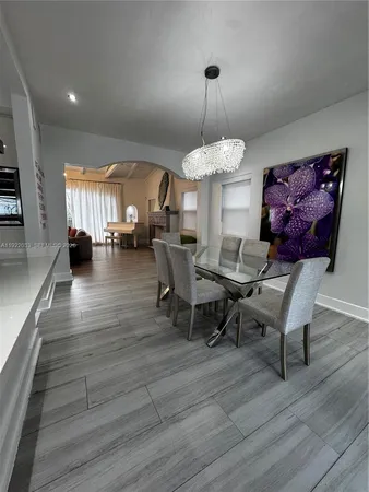 a view of a living room with a red door and a window