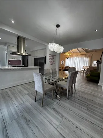 a patio with a table and chairs under an umbrella