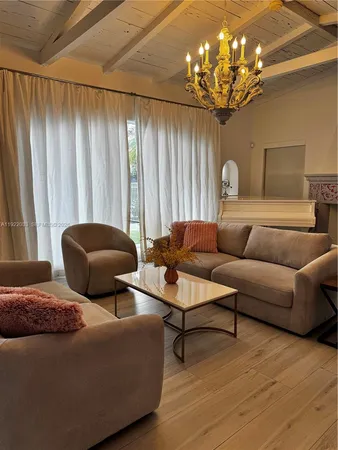 a large kitchen with stainless steel appliances a large counter top a stove and a refrigerator