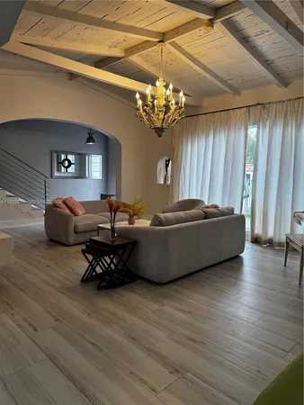 a dining room with furniture and wooden floor