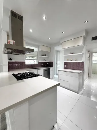 a spacious bedroom with a bed and a flat screen tv