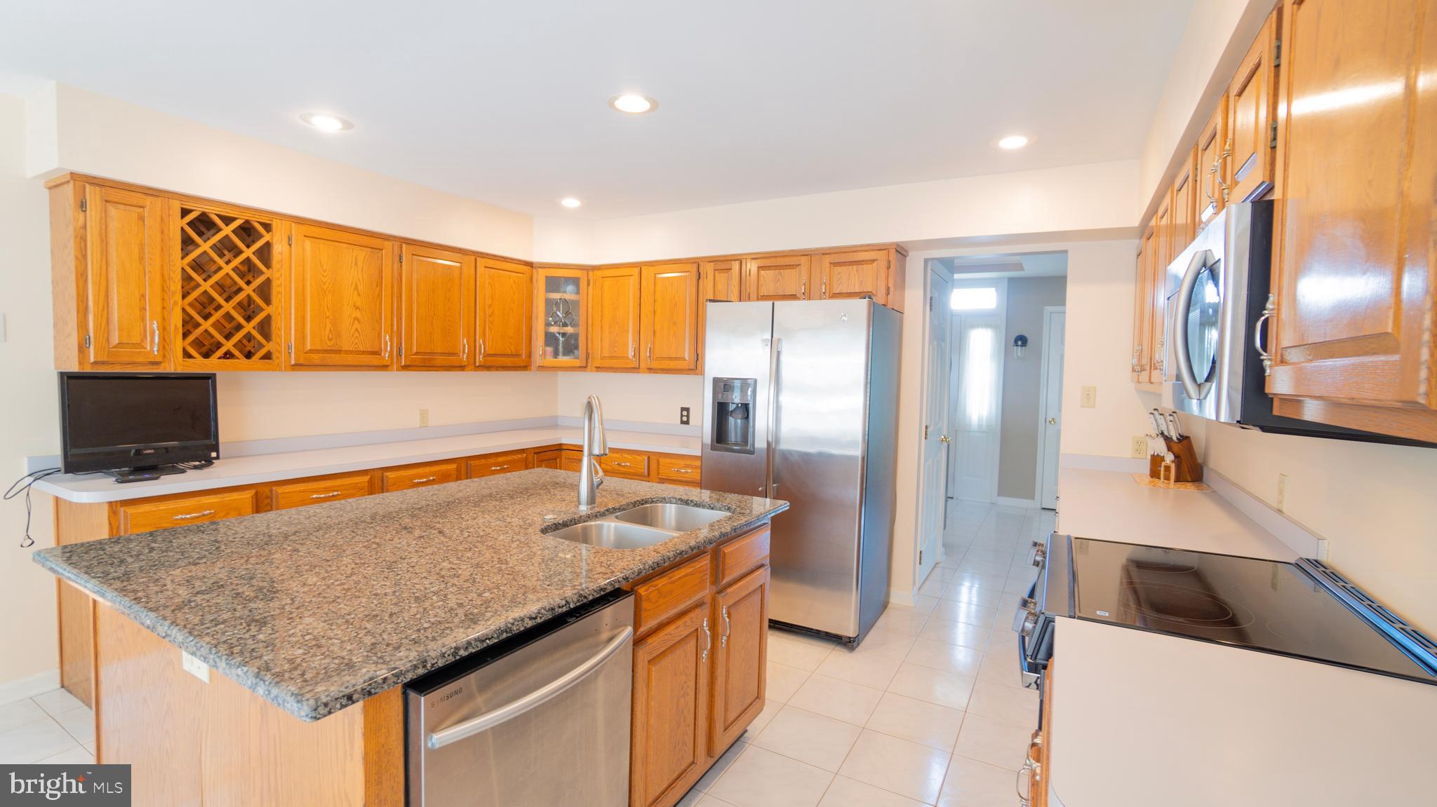 1042 Country Club Road Camp Hill, PA 17011 - Photo 16 of 41 a kitchen with stainless steel appliances granite countertop a sink and a refrigerator