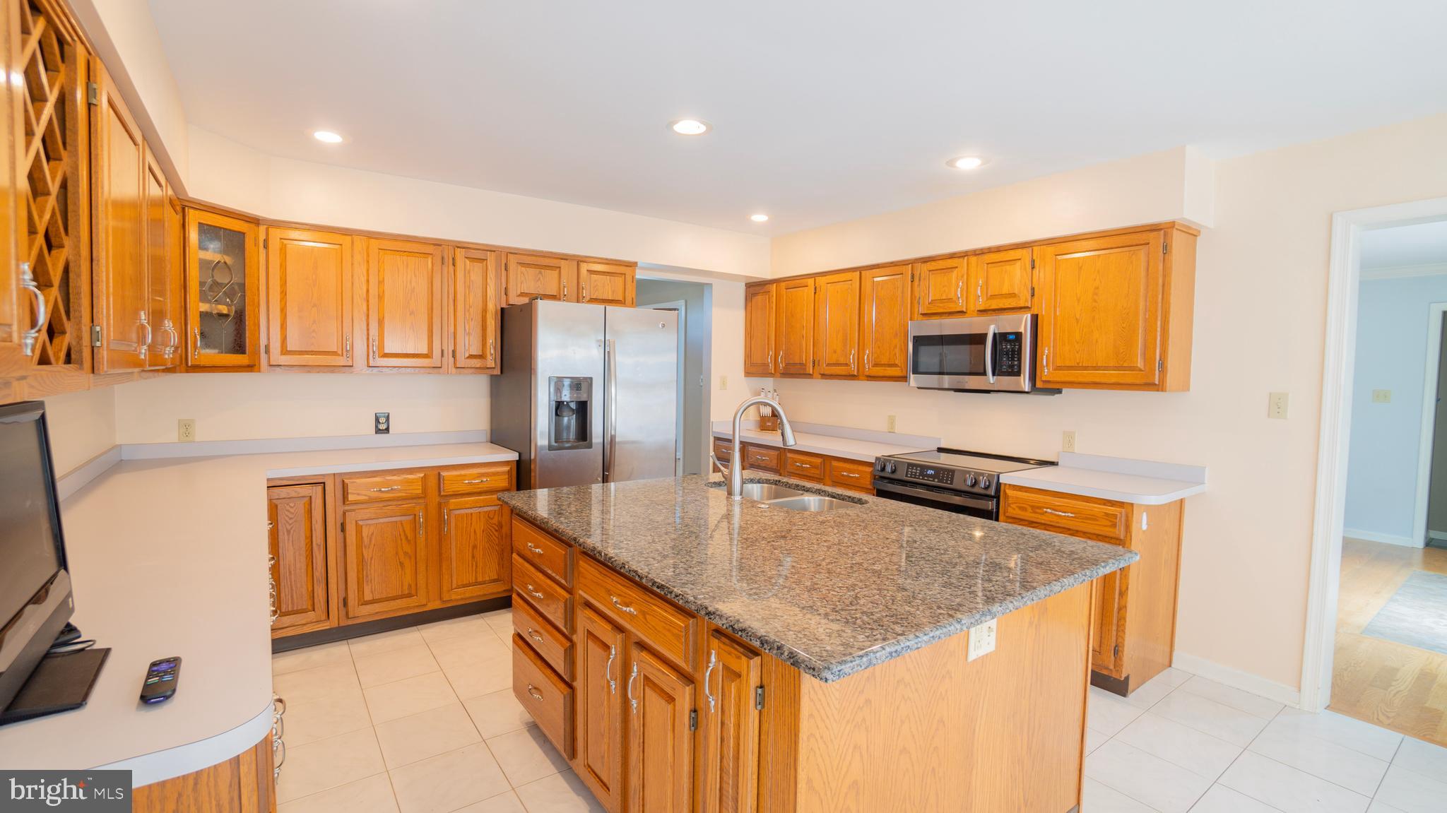 1042 Country Club Road Camp Hill, PA 17011 - Photo 17 of 41 a kitchen with stainless steel appliances granite countertop a sink a stove a refrigerator a center island and a cabinets