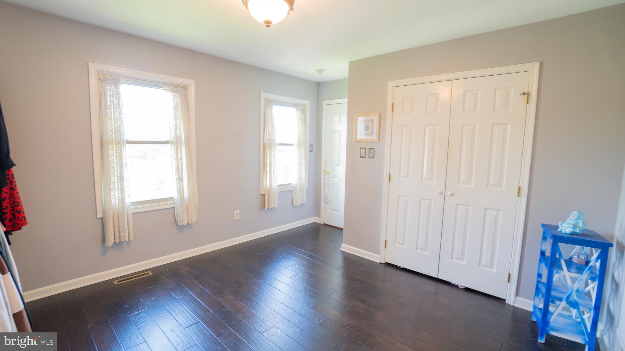 1042 Country Club Road Camp Hill, PA 17011 - Photo 27 of 41 an empty room with wooden floor and windows
