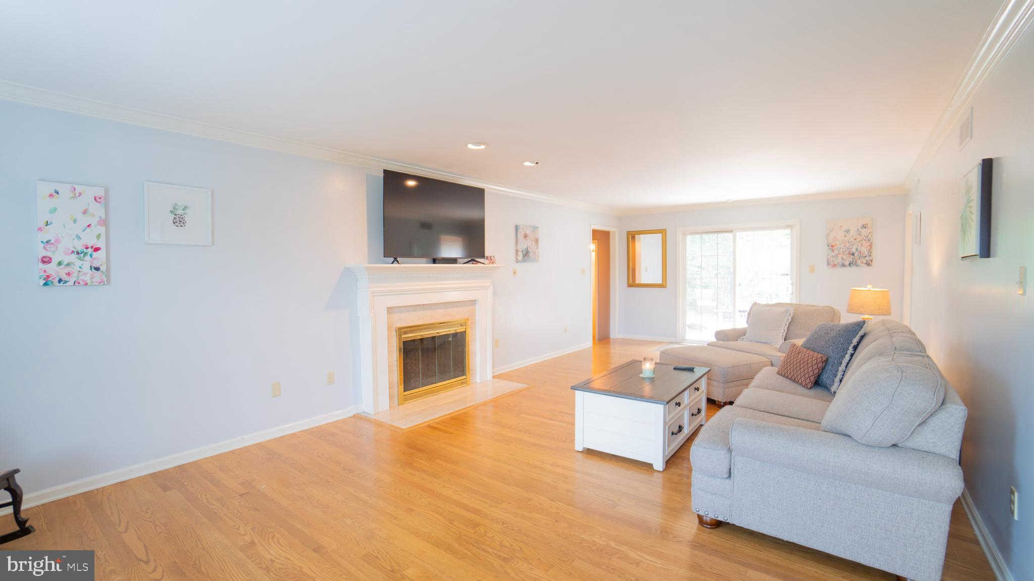 1042 Country Club Road Camp Hill, PA 17011 - Photo 8 of 41 a living room with furniture a fireplace and a flat screen tv