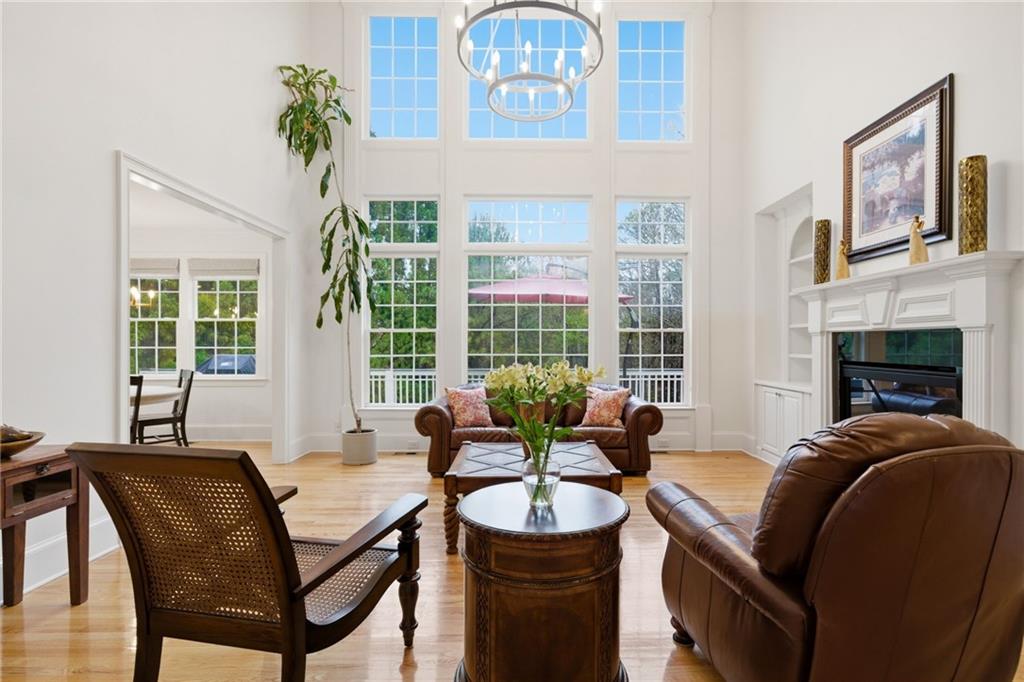2058 Windermere Crossing Cumming, GA 30041 - Photo 12 of 75 a living room with furniture a fireplace and a large window