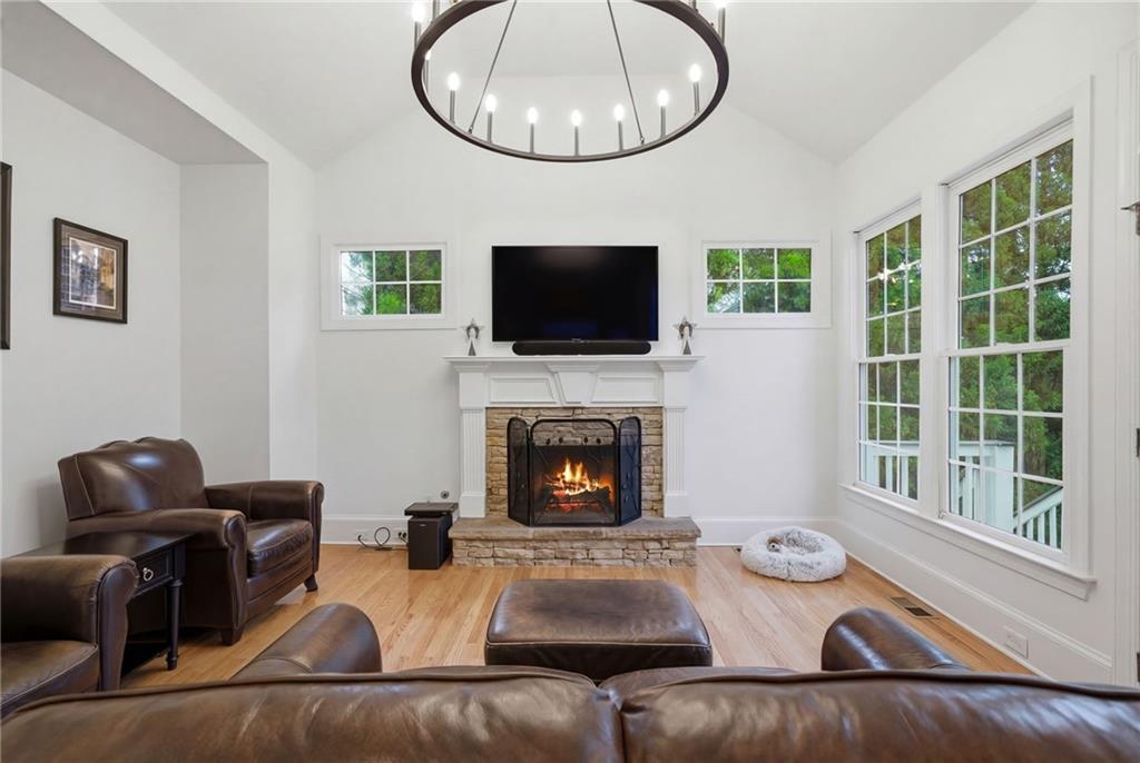 2058 Windermere Crossing Cumming, GA 30041 - Photo 24 of 75 a living room with furniture a fireplace and a flat screen tv