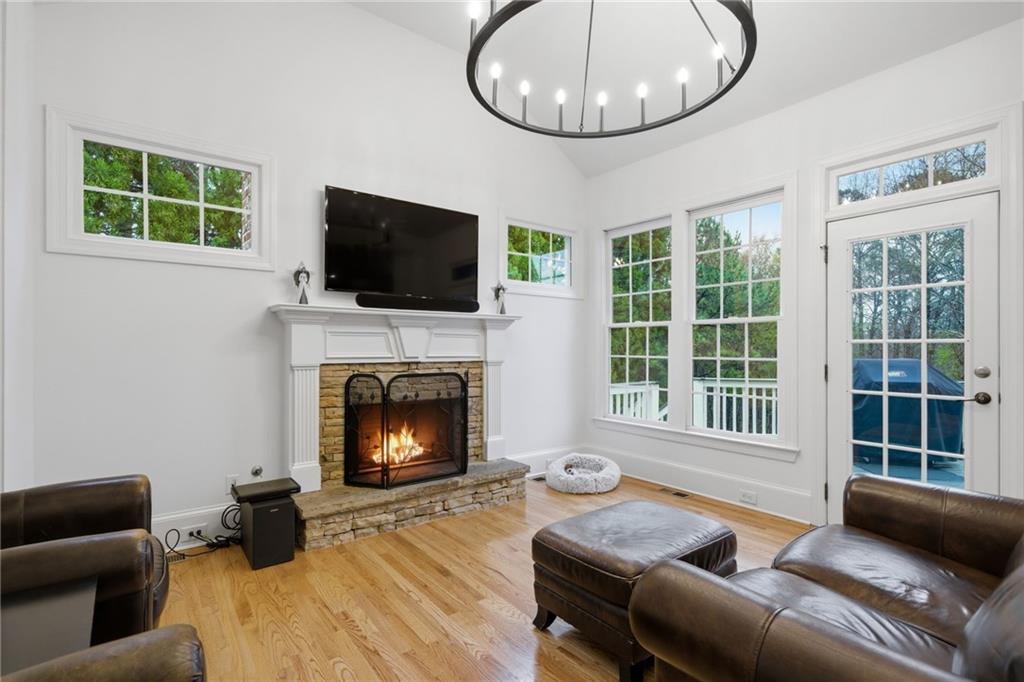 2058 Windermere Crossing Cumming, GA 30041 - Photo 25 of 75 a living room with furniture a fireplace and a flat screen tv