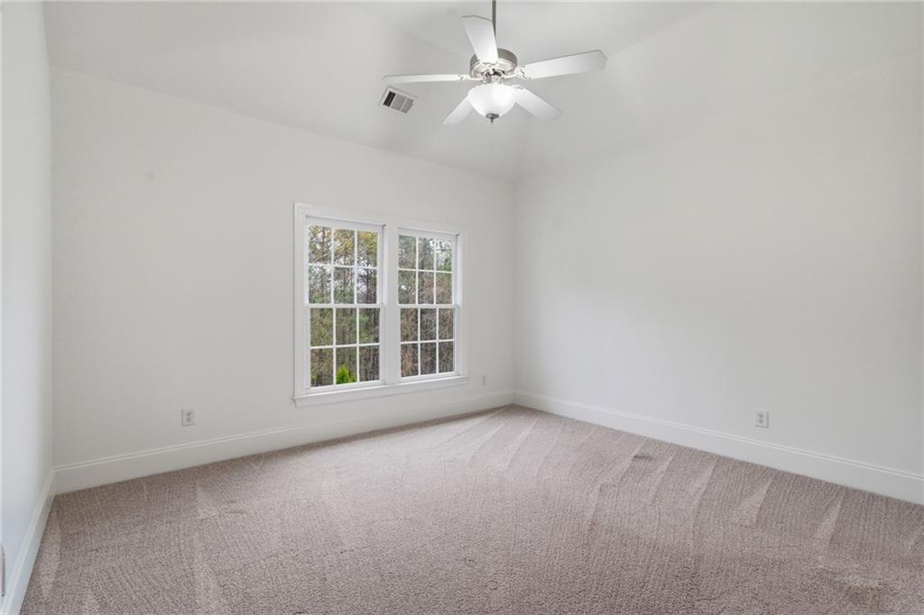 2058 Windermere Crossing Cumming, GA 30041 - Photo 29 of 75 an empty room with a window and a fan
