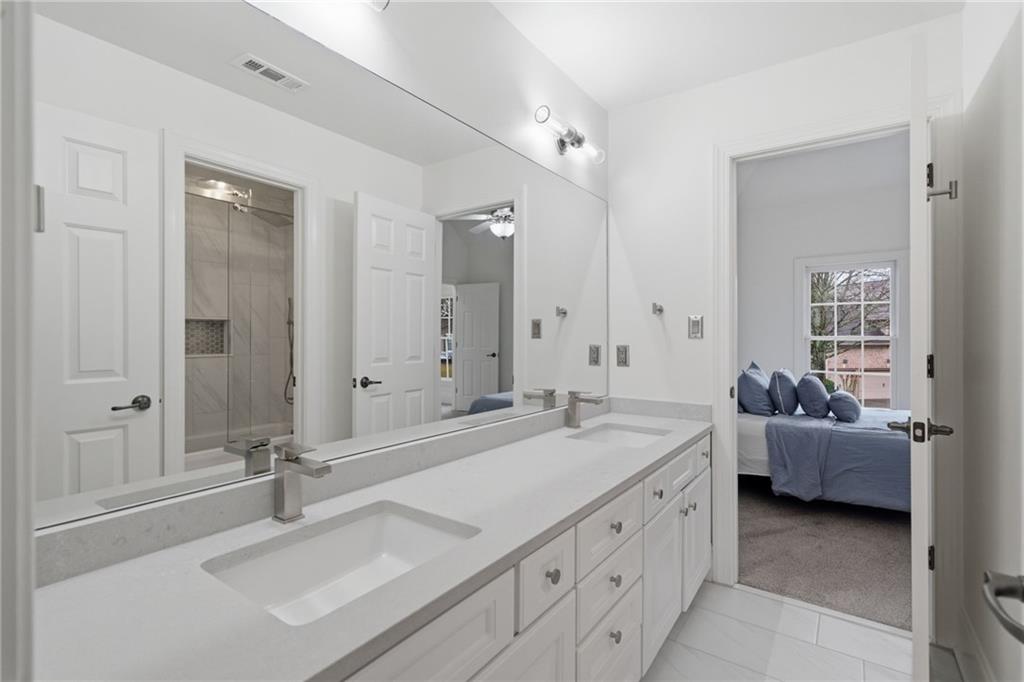 2058 Windermere Crossing Cumming, GA 30041 - Photo 30 of 75 a spacious bathroom with a double vanity sink double and mirror