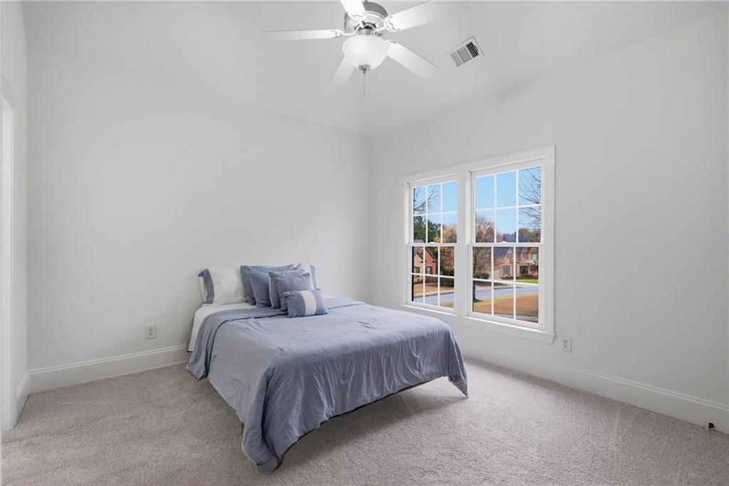 2058 Windermere Crossing Cumming, GA 30041 - Photo 32 of 75 a bedroom with a bed and window