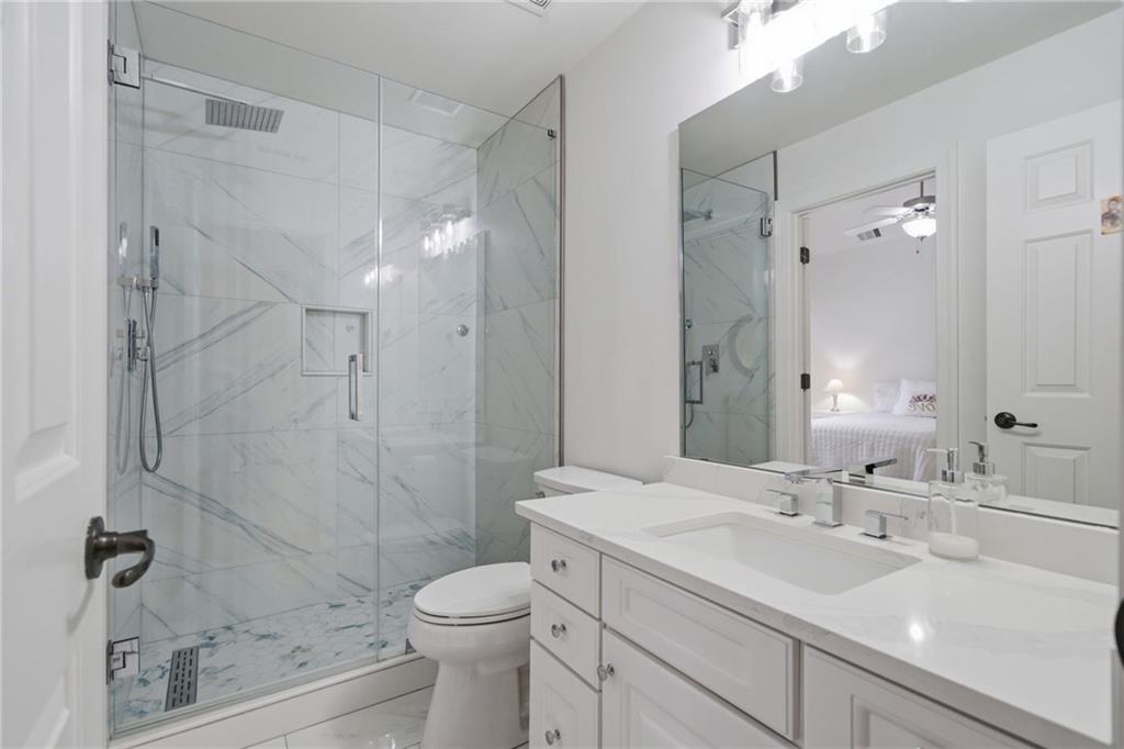 2058 Windermere Crossing Cumming, GA 30041 - Photo 34 of 75 a bathroom with a sink a toilet and shower