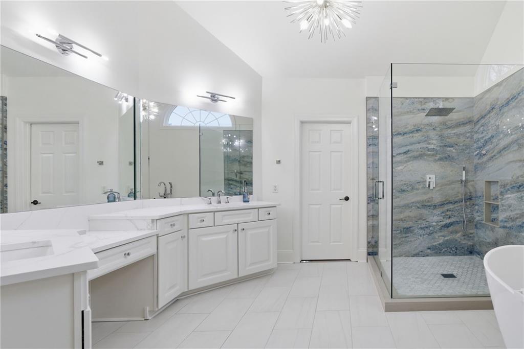 2058 Windermere Crossing Cumming, GA 30041 - Photo 39 of 75 a spacious bathroom with a shower a sink and a mirror