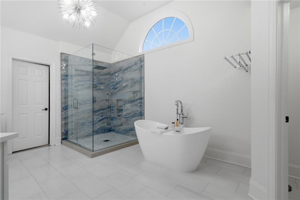 2058 Windermere Crossing Cumming, GA 30041 - Photo 40 of 75 a bathroom with a sink a mirror and a bathtub