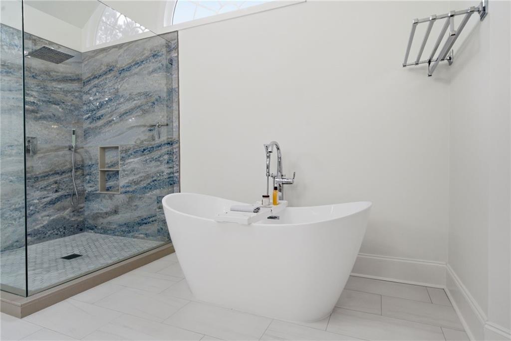 2058 Windermere Crossing Cumming, GA 30041 - Photo 41 of 75 a white bath tub sitting next to a shower