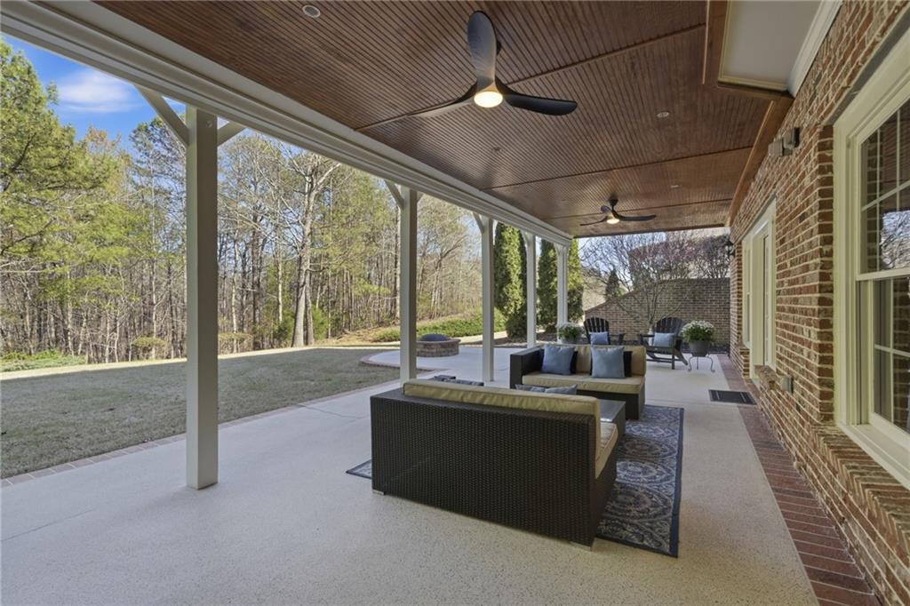 2058 Windermere Crossing Cumming, GA 30041 - Photo 48 of 75 a living room with furniture and a floor to ceiling window