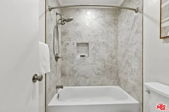 a bathroom with a shower and a bath tub