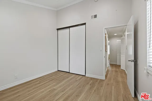wooden floor in a hall with an empty room