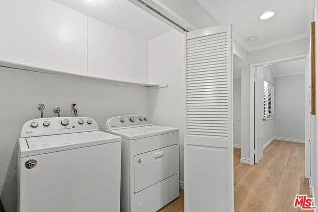 a view of storage and utility room with washer and dryer