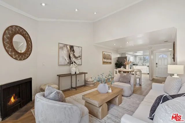 a living room with furniture a rug and a fireplace