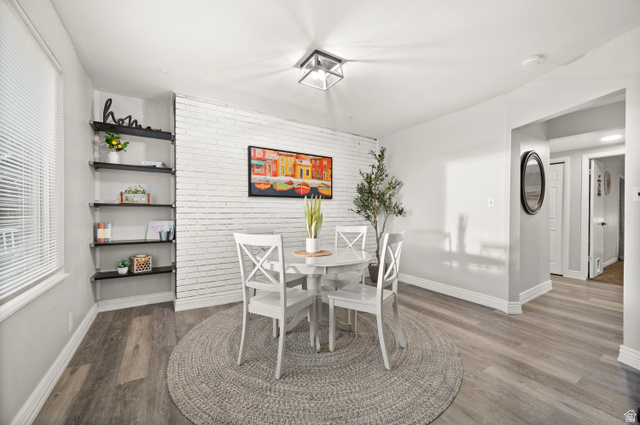 9750 Indian Ridge Drive Sandy, UT 84092 - Photo 31 of 40 Dining room with brick wall and dark wood finished floors